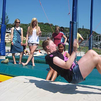 Front Flippin' Campers practice on mats before heading over to the trampolines and finishing at the water ramps. Here, a camper demonstrates the right way to do…