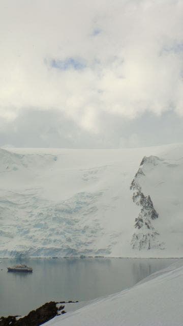 T. Laakso climbing above fjord in Admiralty Bay  