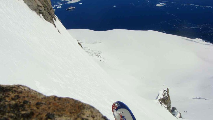 The first run Skiing Mag Editor, Sam Bass about to drop in to ramp on Weincke, 1st run, ship in distance.