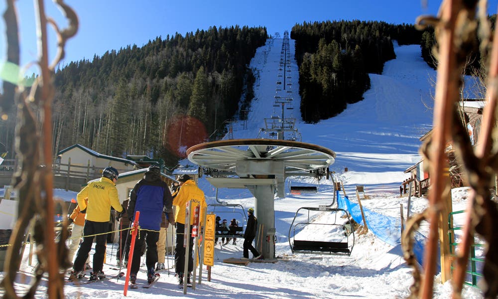 Chair 1 Looking up Chair 1 and the famed Al's Run the yellow jackets of Taos Ski School get ready to load for the season.