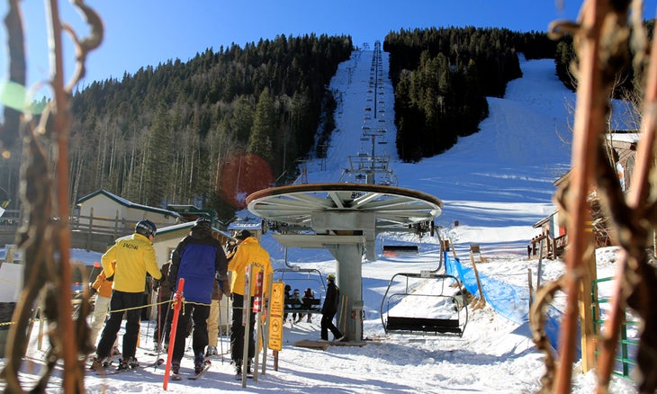 Chair 1 Looking up Chair 1 and the famed Al's Run the yellow jackets of Taos Ski School get ready to load for the season.