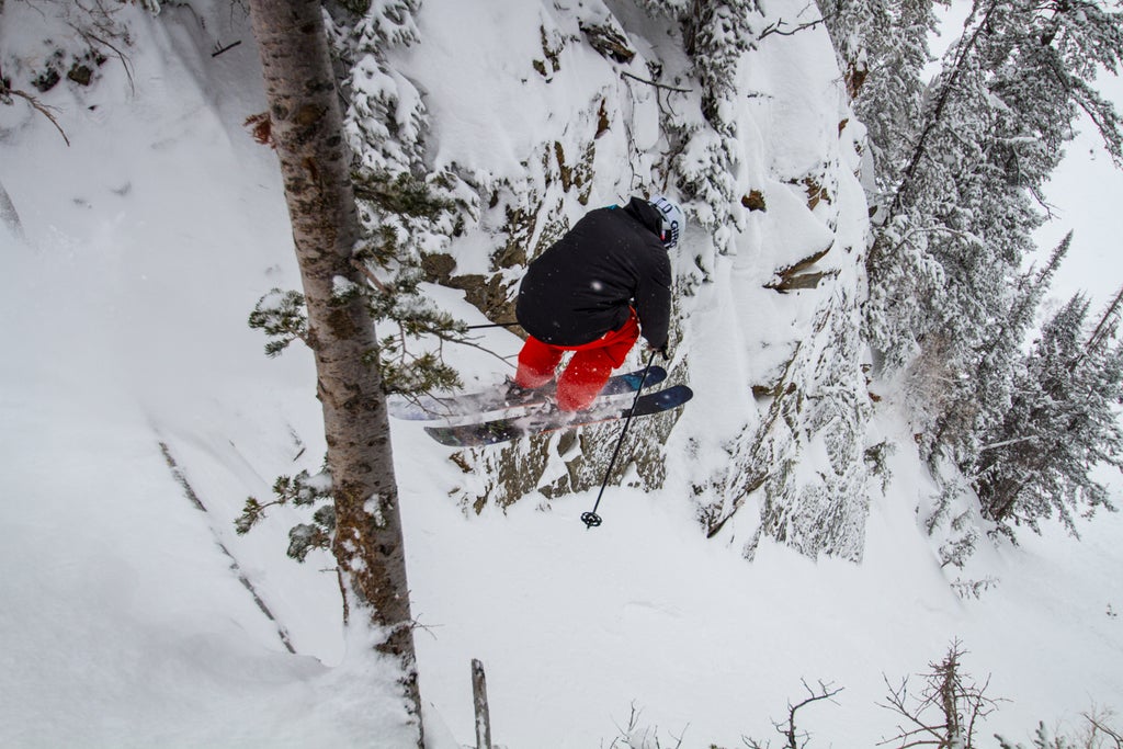 Skier Tim Dyer jumps into a steep run