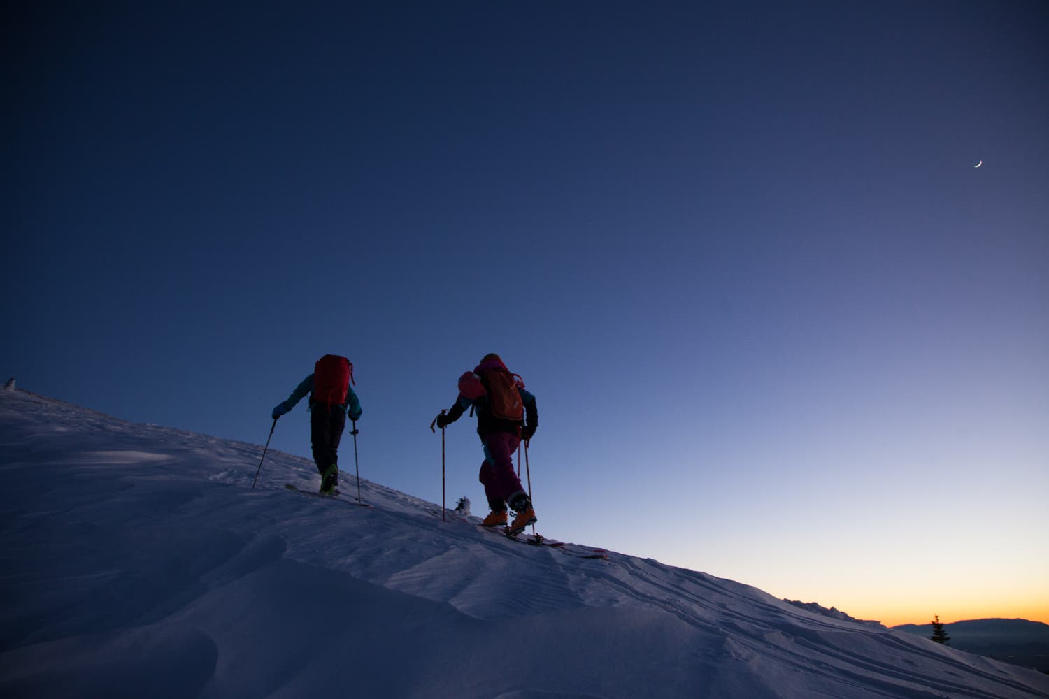 Lynsey and Caroline working hard until the last light.  The behind-the-scenes story of this shot is representative of what it’s like to make a ski…
