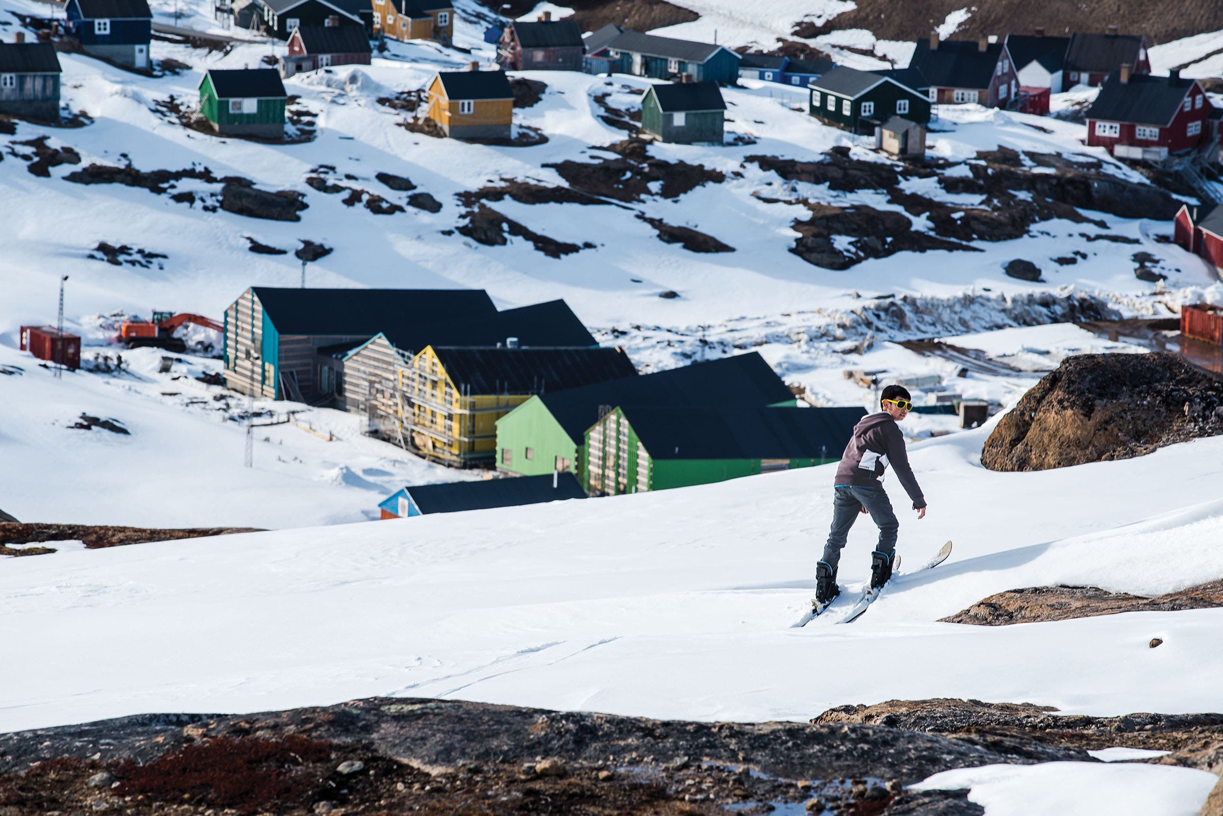 A young boy in too-big boots takes a “hot lap” on the rope tow above the town of Tasiilaq. “It took him about 30 minutes to get down,” Long says,…