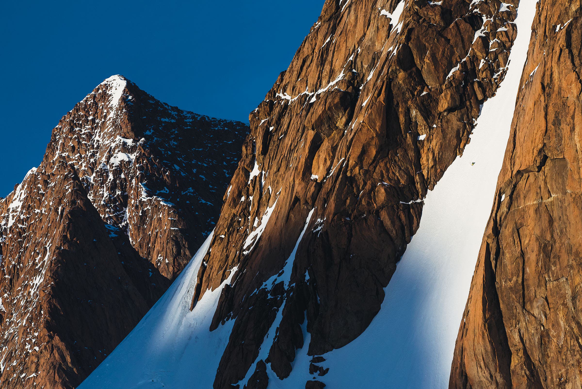 SKG1216_PHO9_Greenland Rubens rips steep corn snow on a massive glacier near Mont Forel, right down to the valley bottom. “One of the first and best lines of the trip,”…