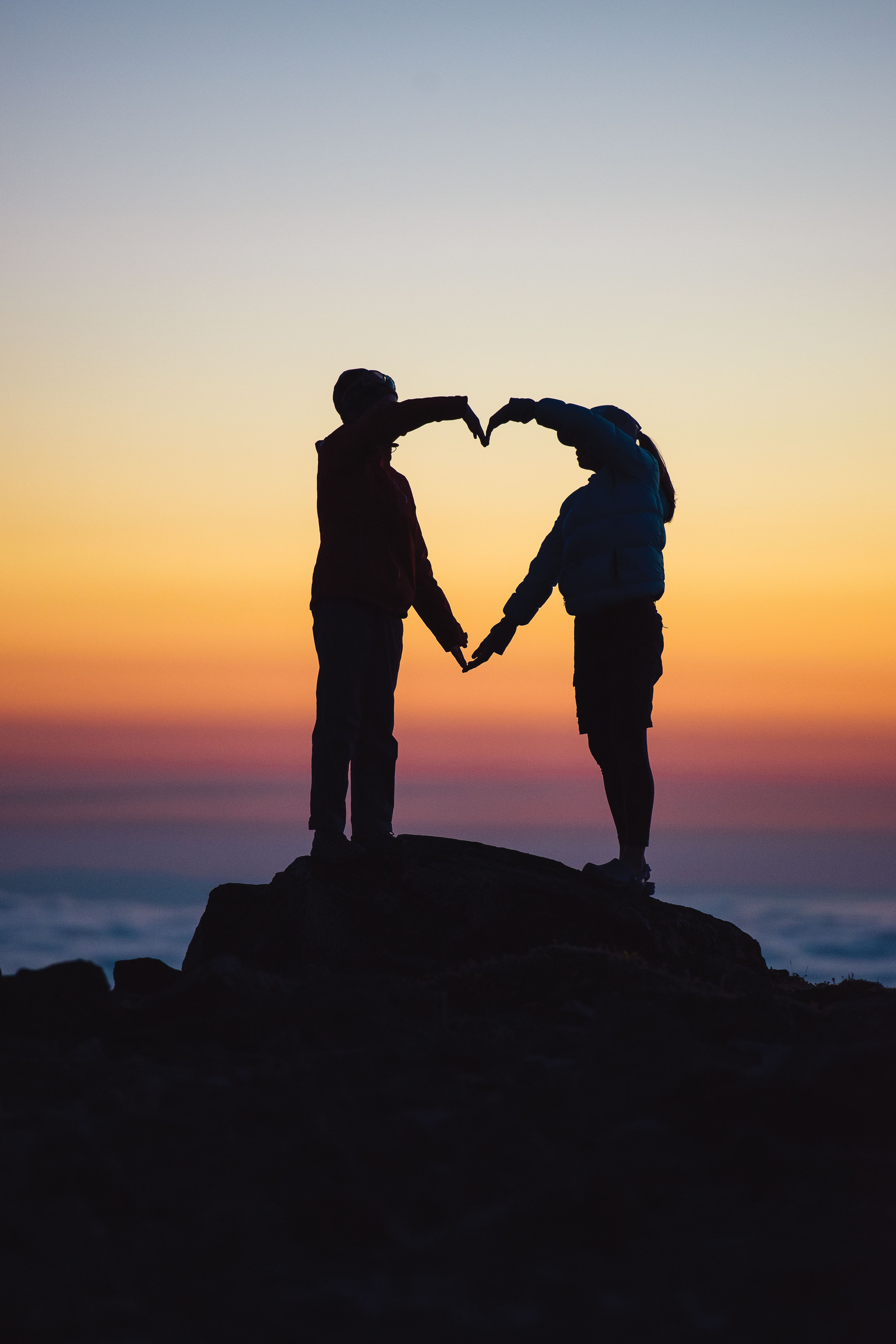 Brianna Rich and Poppy Knorr form a tribute to Adam Robertson Observation Rock. Adams died in an avalanche on Dec. 27, 2016.
