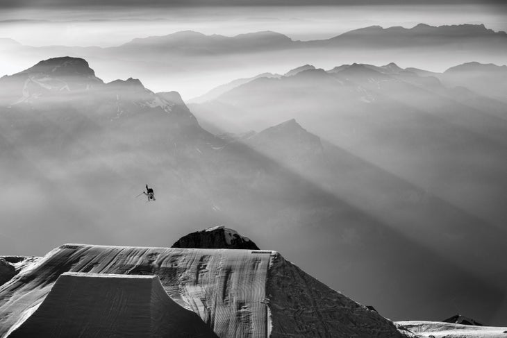 SKI0218_FOC_OskarEnander FLYING HIGH With the fog-shrouded Alps as his backdrop, Italian pro freeskier Christof Schenk catches big air off a kicker built for the Fabian Bösch…