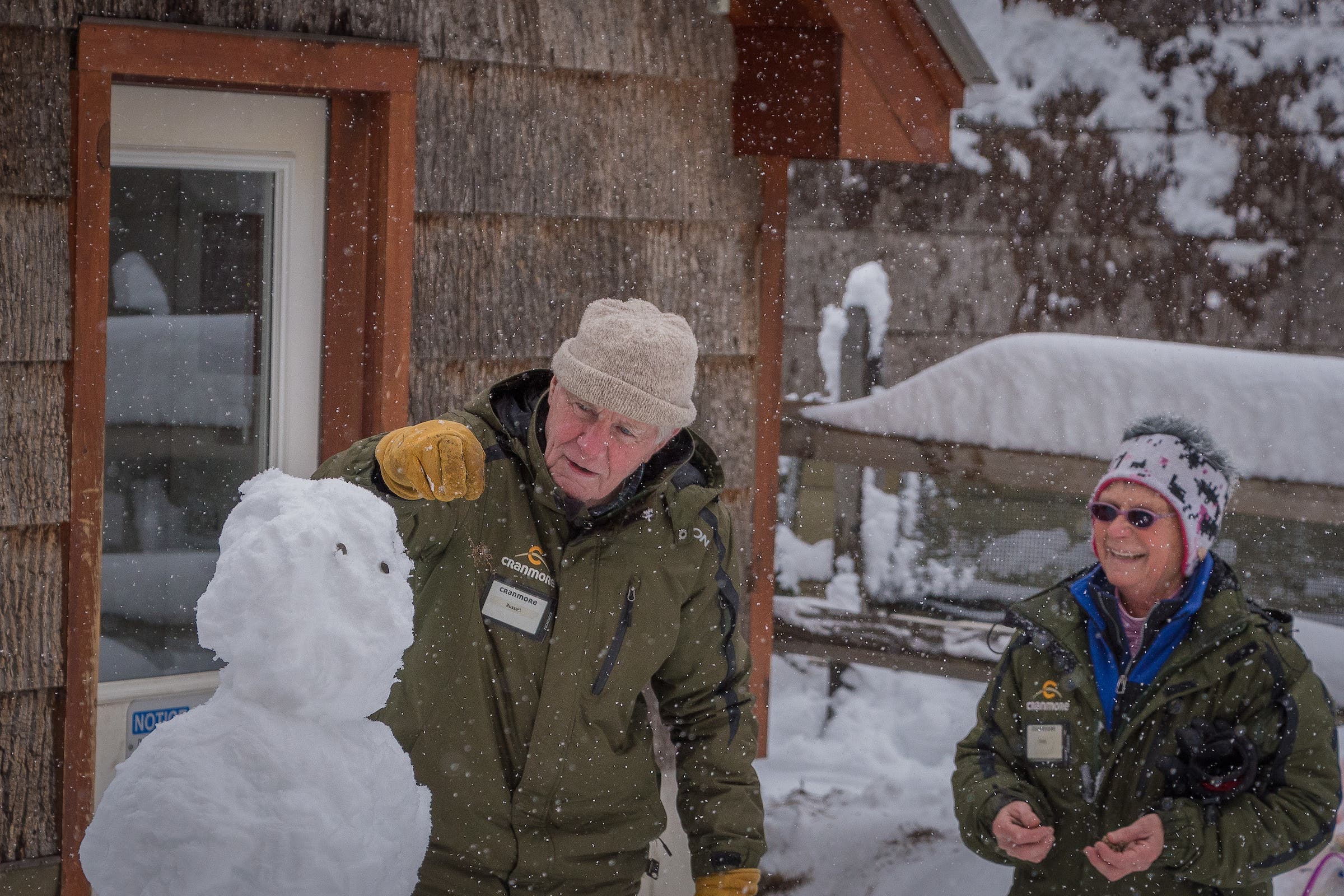 Russel Veale and Cindy Whitaker build a snowman.