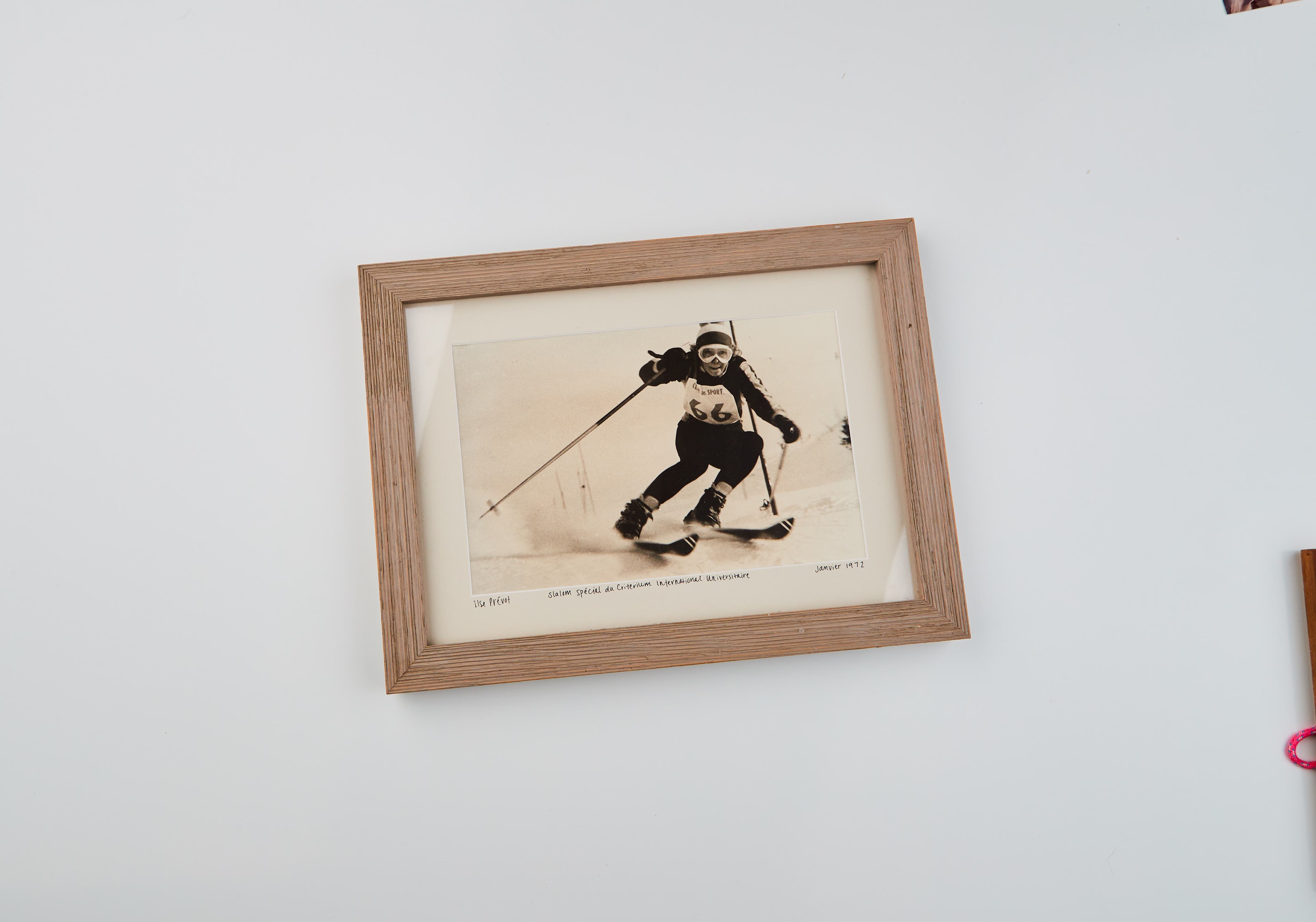 1920 Catalog Flatlays 1 Sepia toned photo in a wood frame of Ilse Prevot ski racing in France