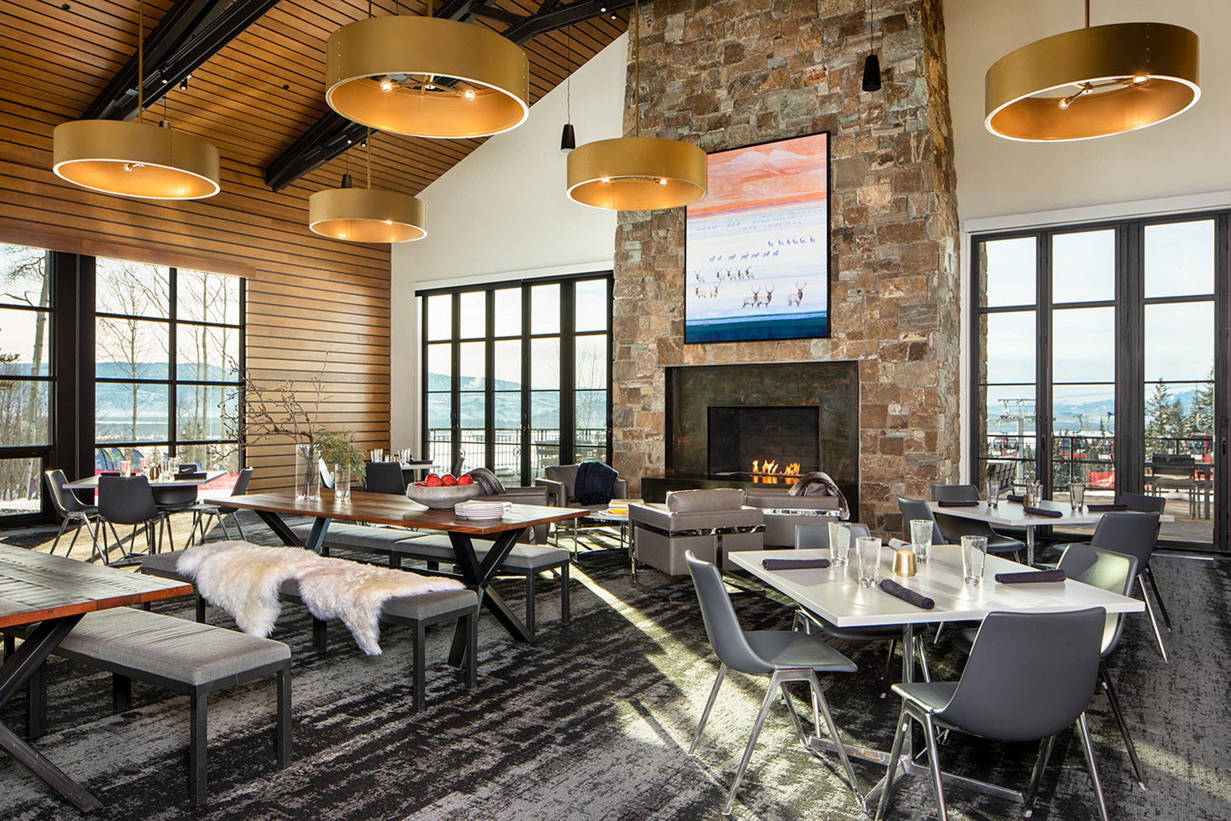 SKI1119-TRA-JHMR-Courtesy-solitude_1 copy Solitude Station at Jackson Hole Mountain Resort indoor space with tables, fire place, and a few large windows