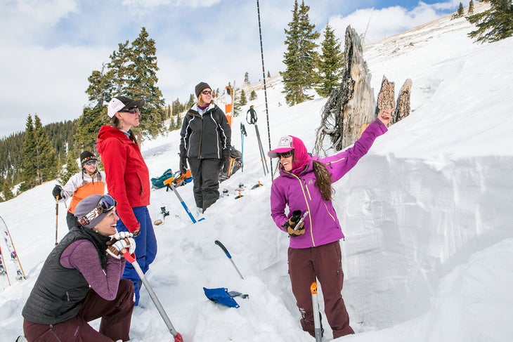 SKI0119-Camps-BackcountryBabes2-byLeisaGibson_S Backcountry Babes instructor Eryka Thorley digs a snowpit to show the group the different layers of snow, and how each can impact our safety.