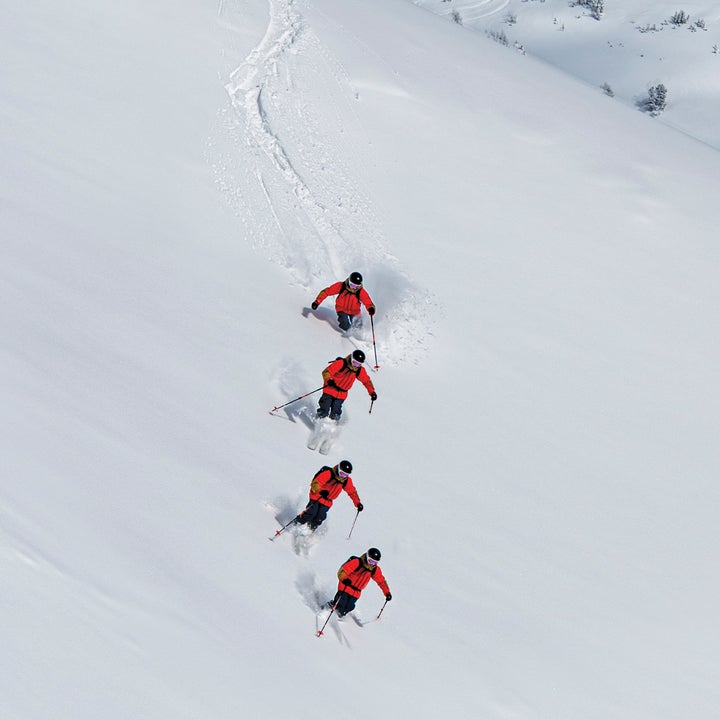 A sequence of a skier skiing in powder