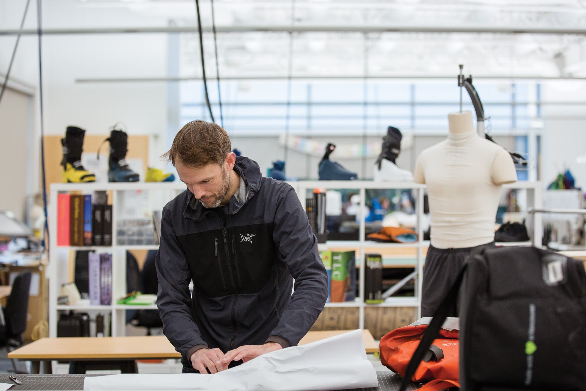 Arcteryx Rock Solid Used Gear program, employee working on buy back product"