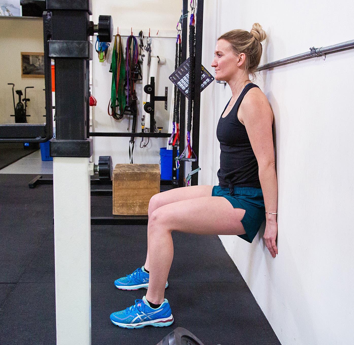 Jessi Hackett performs a wall sit at the Alpine Training Center, Boulder, Colo.