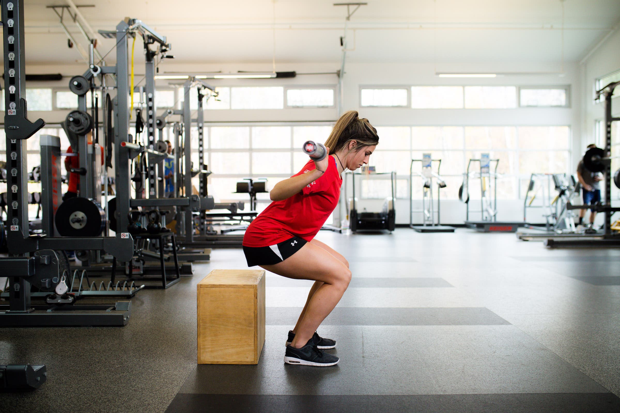 Athlete performs weighted box squat
