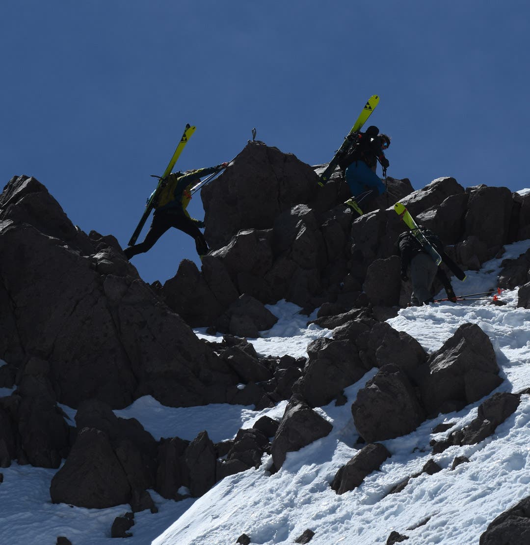 Three skier climbing on rocks on Lassen Peak