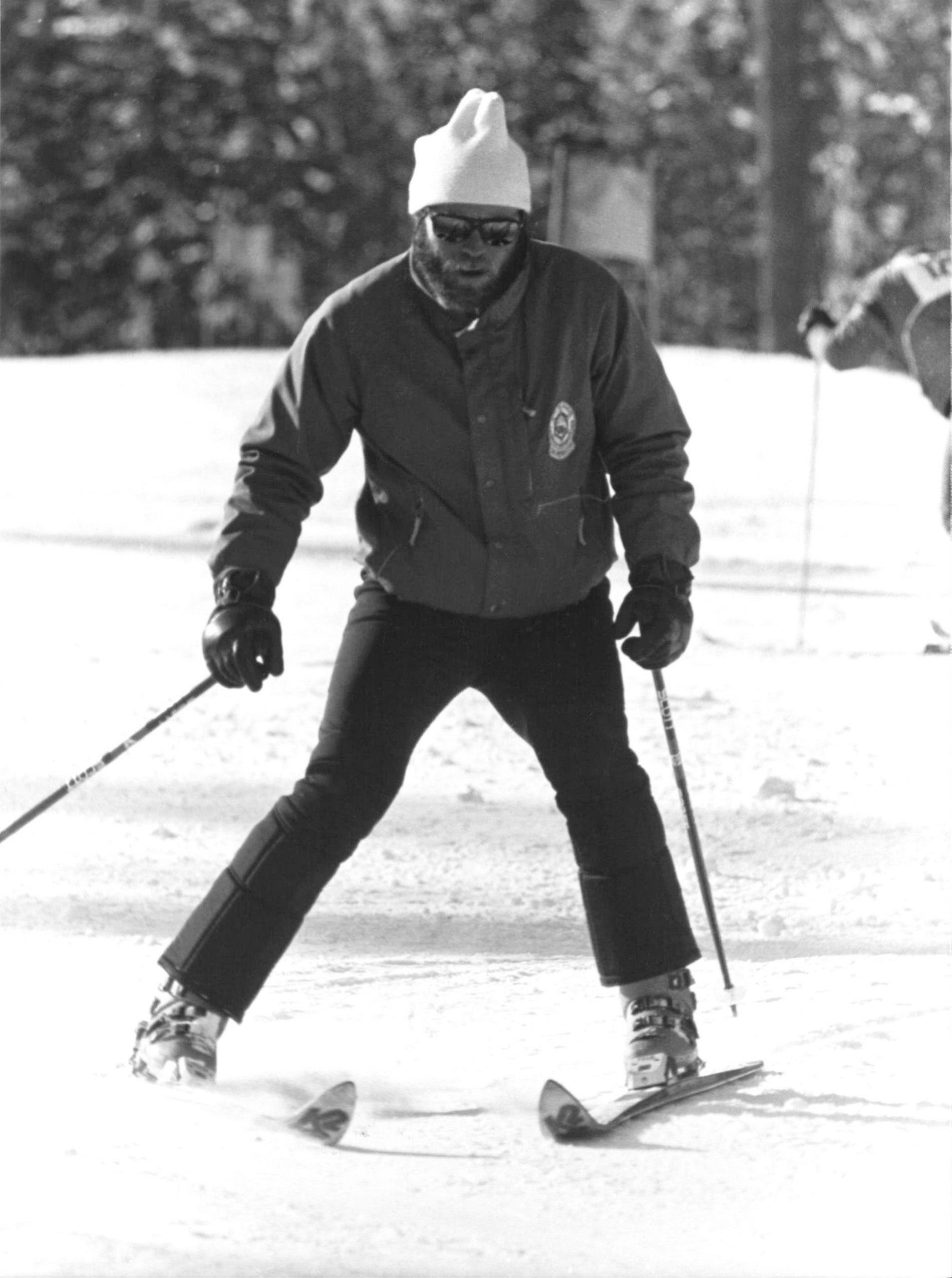 Ski instructor dad performs a wedge turn
