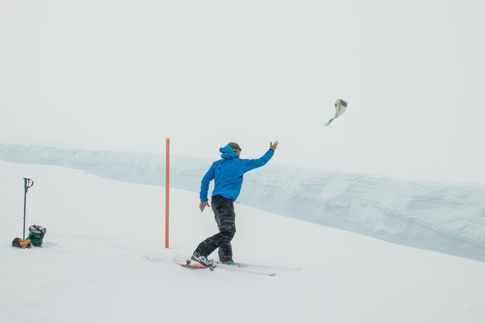 A guide on Denali throws poop into a crevasse.