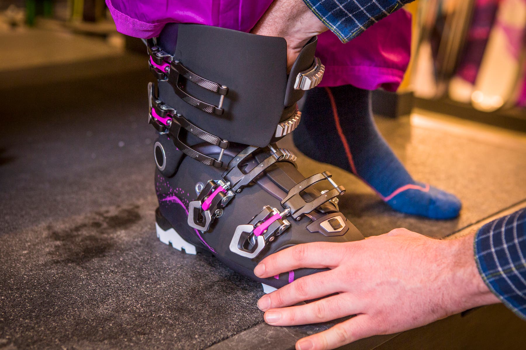Ski bootfitter helps customer with ski boot fit