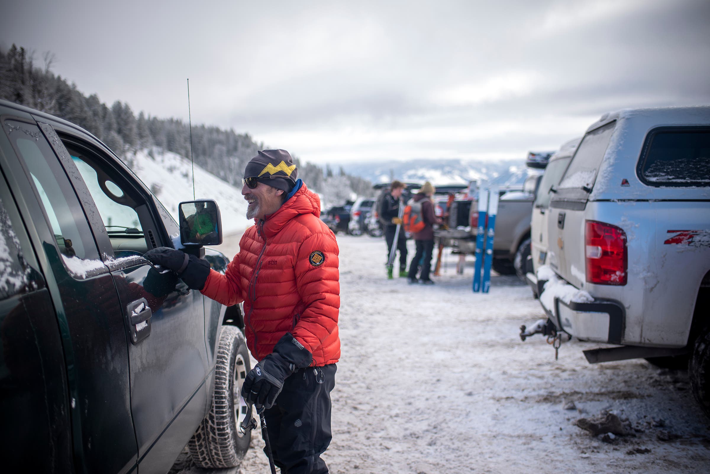 TCBA volunteer in the parking lot at the top of Teton Pass