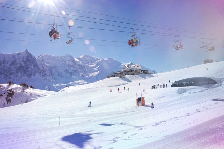 Chair lifts with skiers heading up the mountain