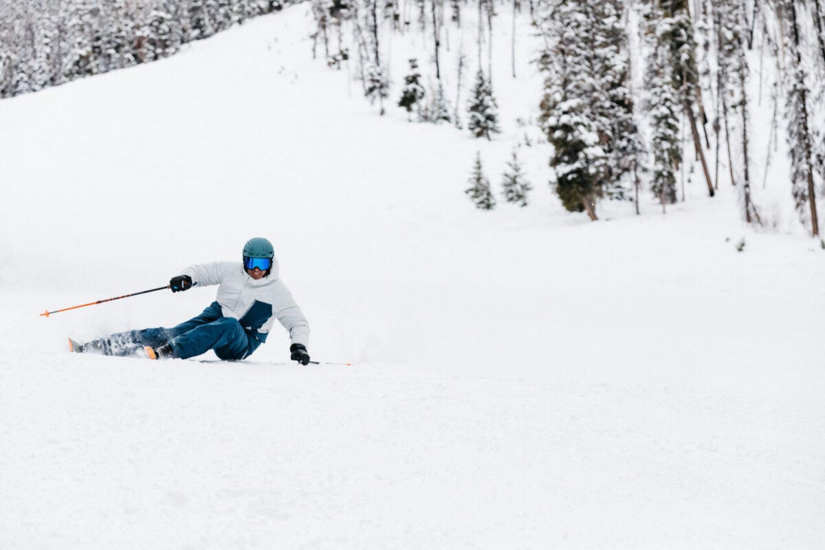 Ski tester carving at extreme edge angles on a groomed slope in Sun Valley, Idaho
