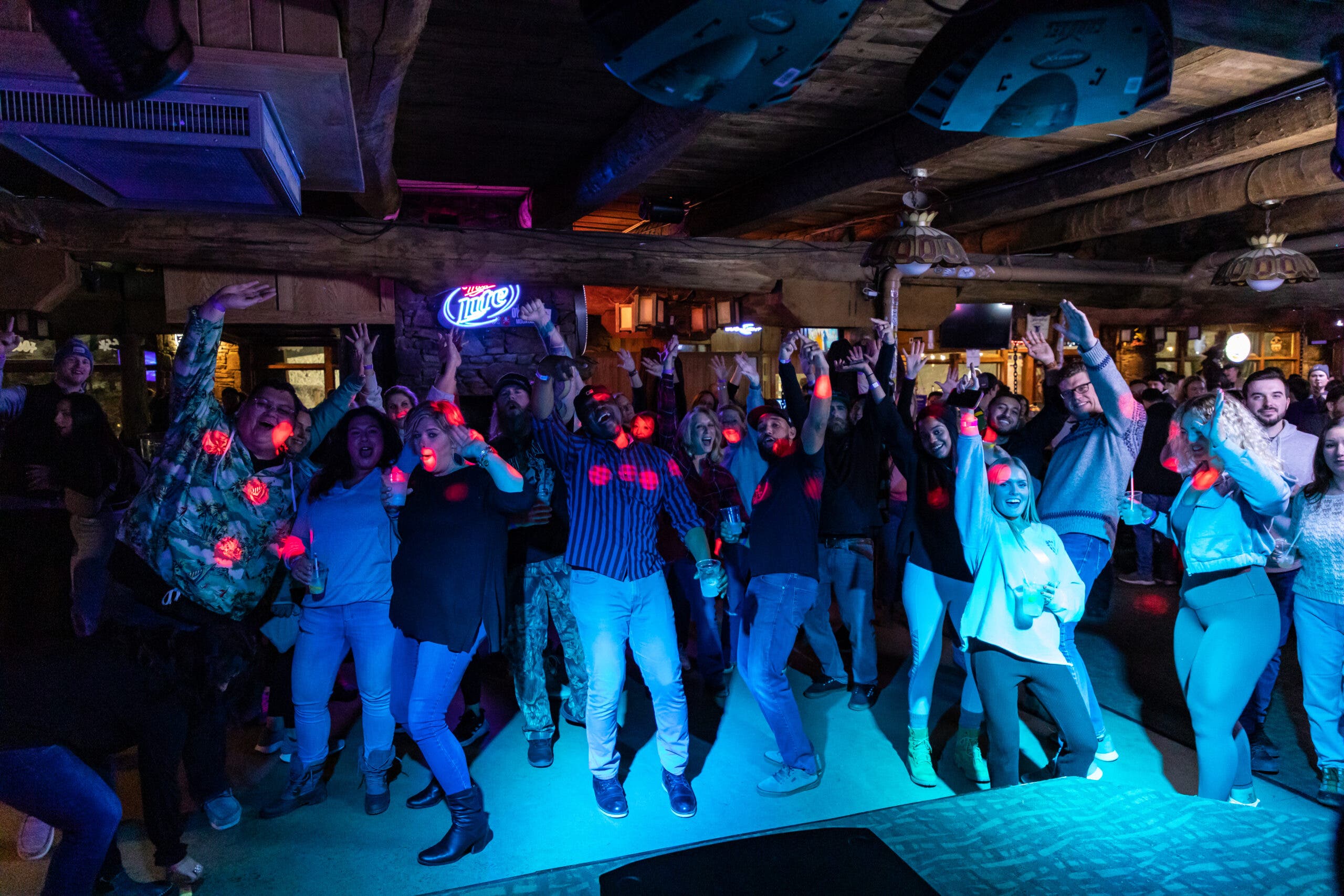 People dancing under neon lights