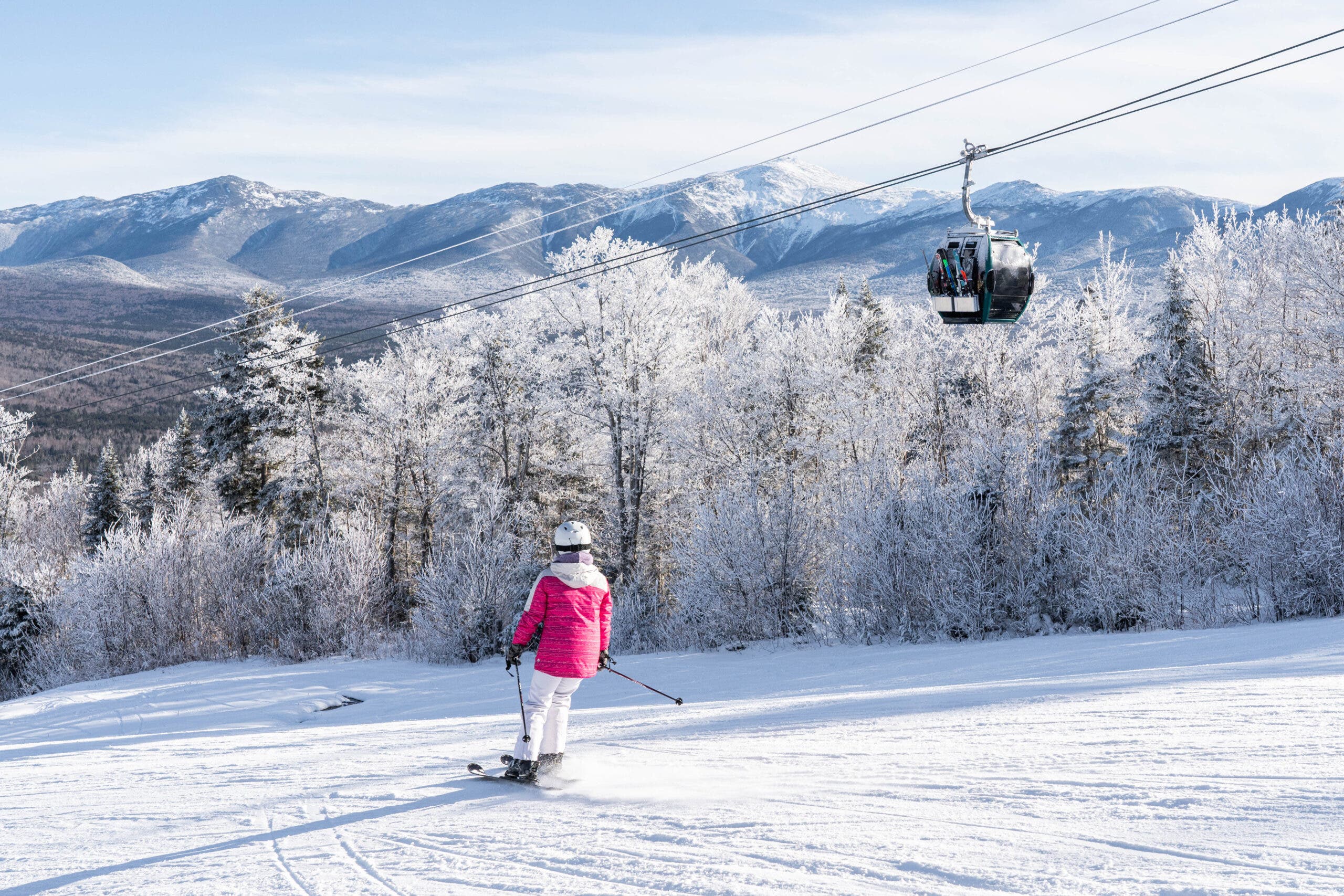 Skier in pink heads down trail at Bretton Woods