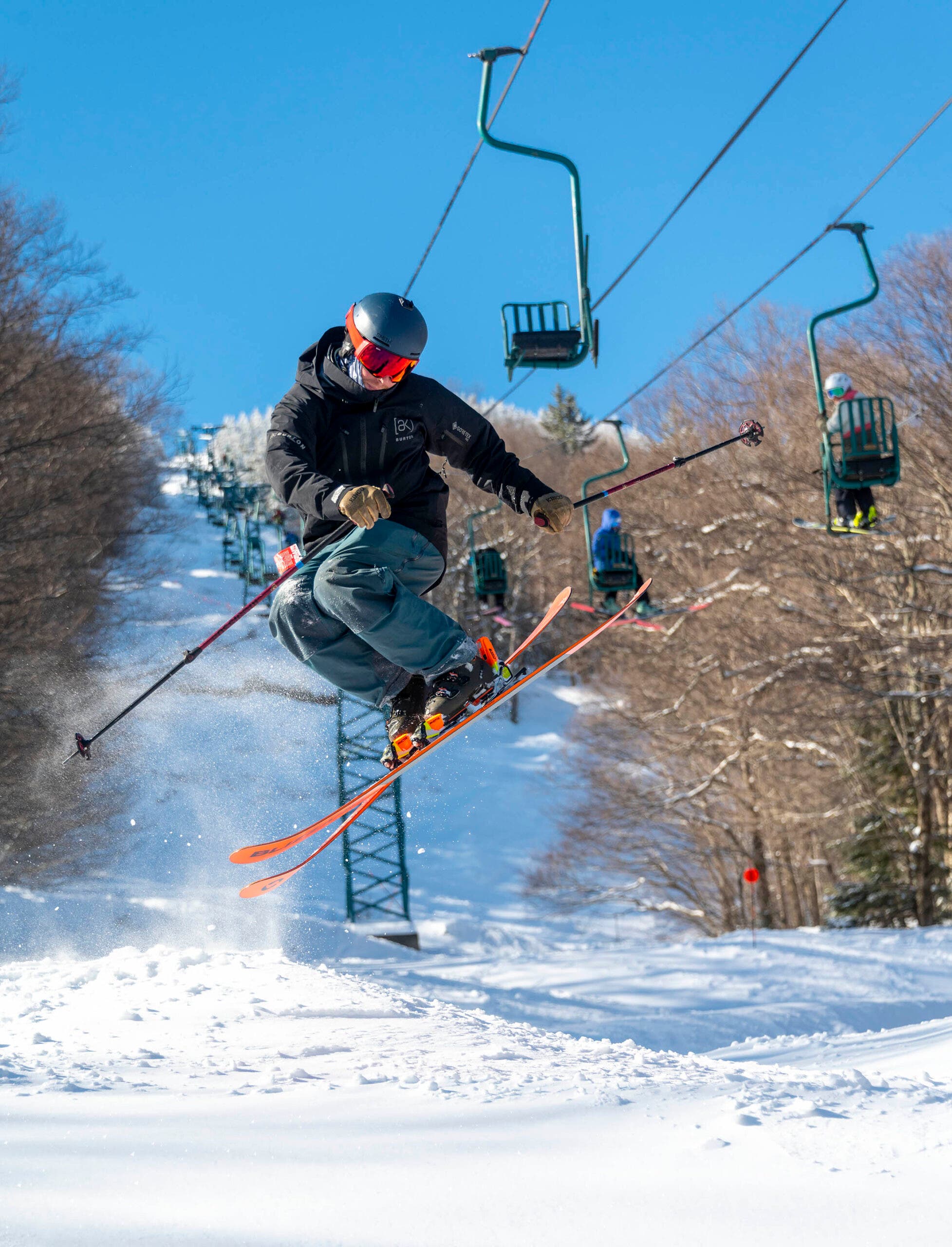 Skier with red skis gets some serious air.