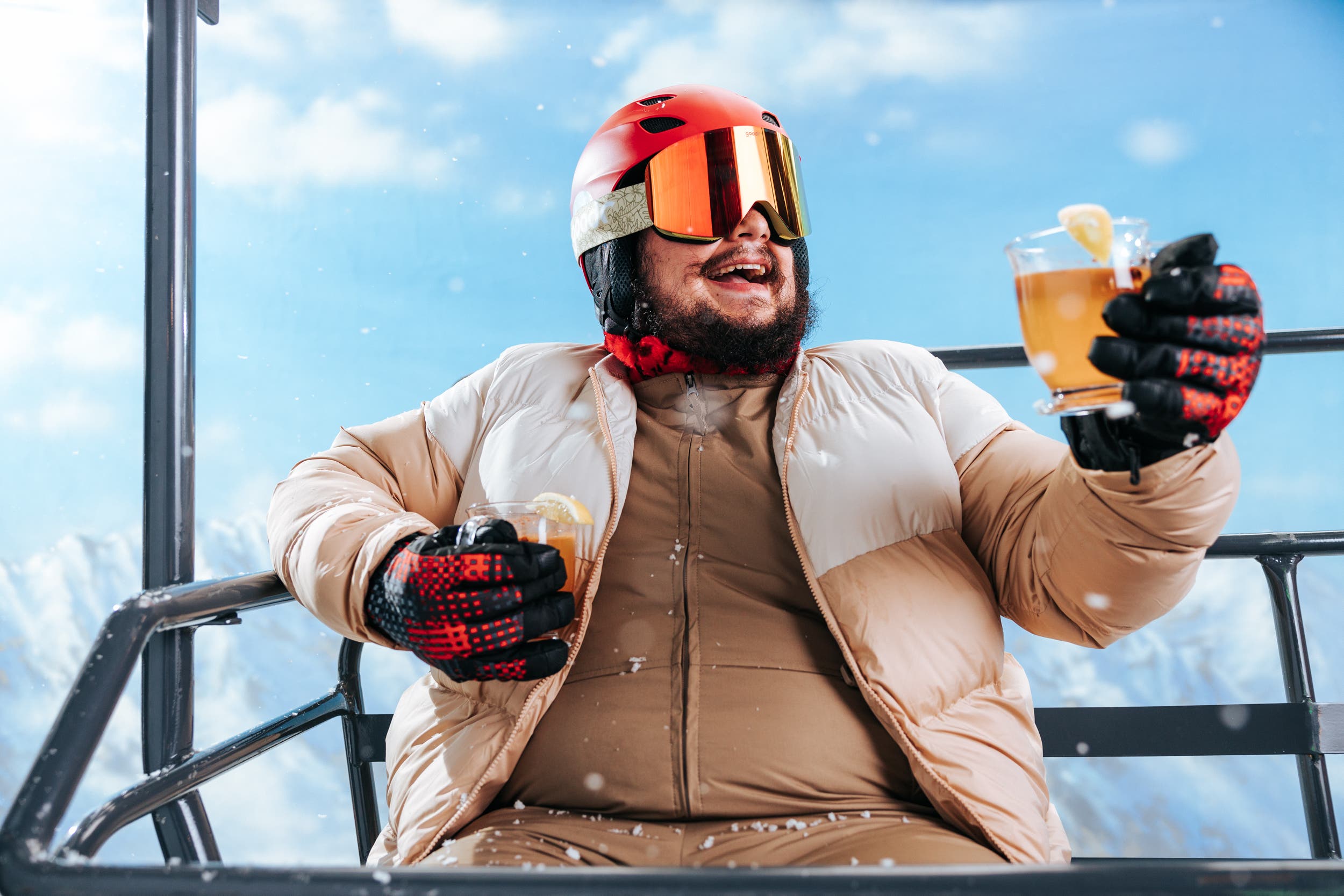 guy on a chairlift drinking a hot toddy