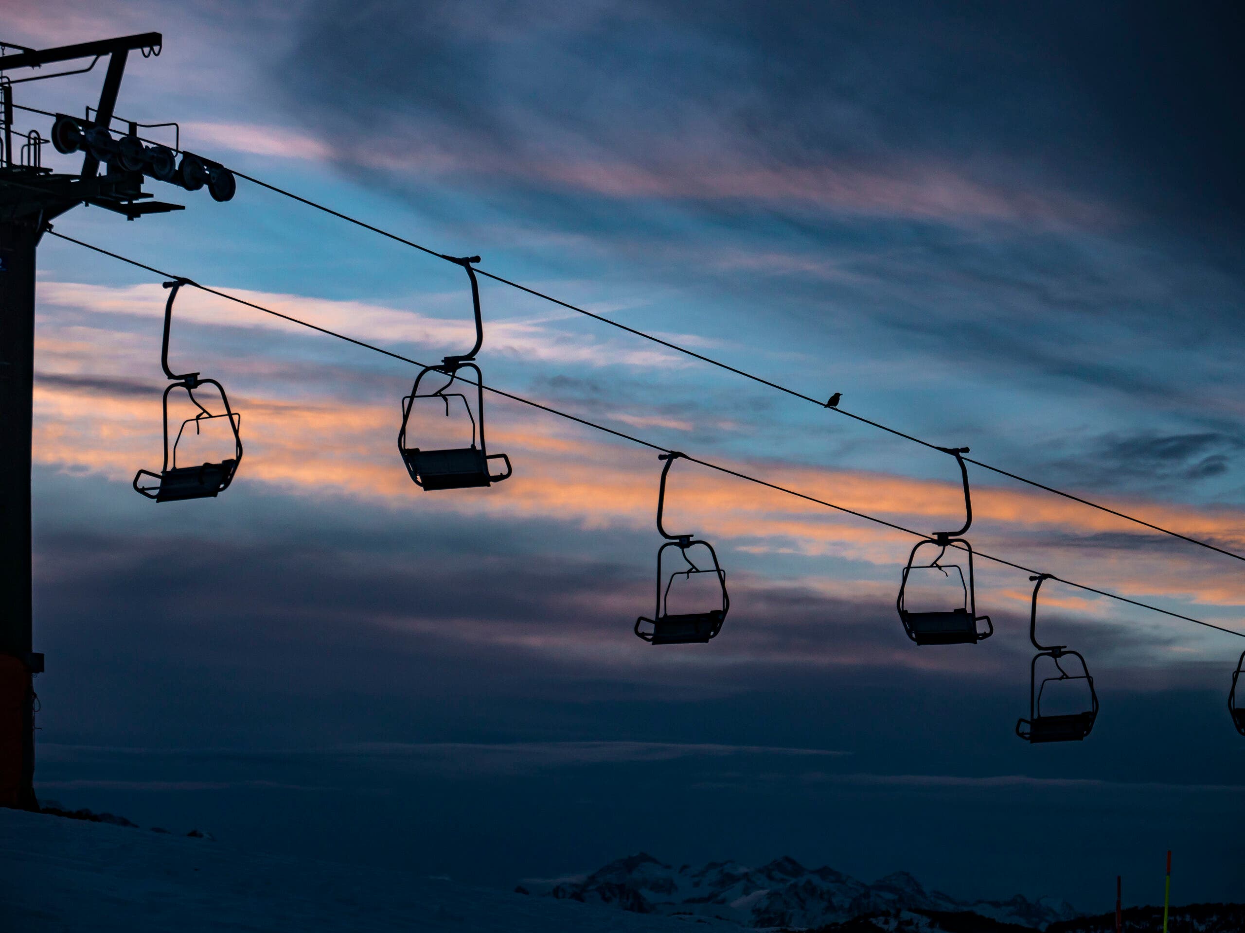 Chairlift against a dark winter sunset