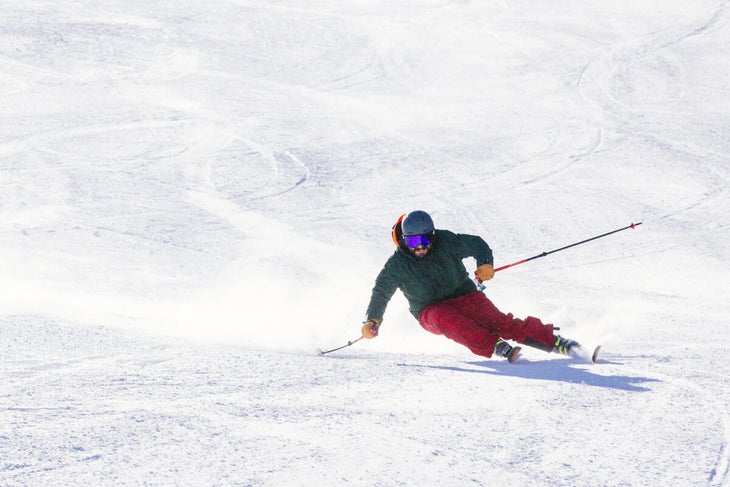 Skiier testing skis goes down mountain