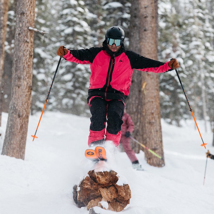 Ski tester jumping off a downed log
