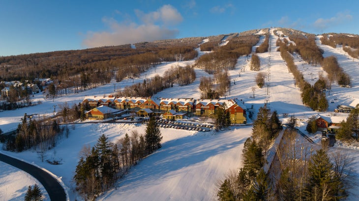 Premium Photo  Skiers sliding down snowy slope on mountain at winter resort