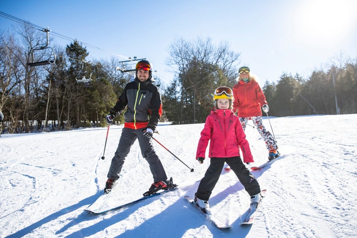 Children skiing with a clear sky.