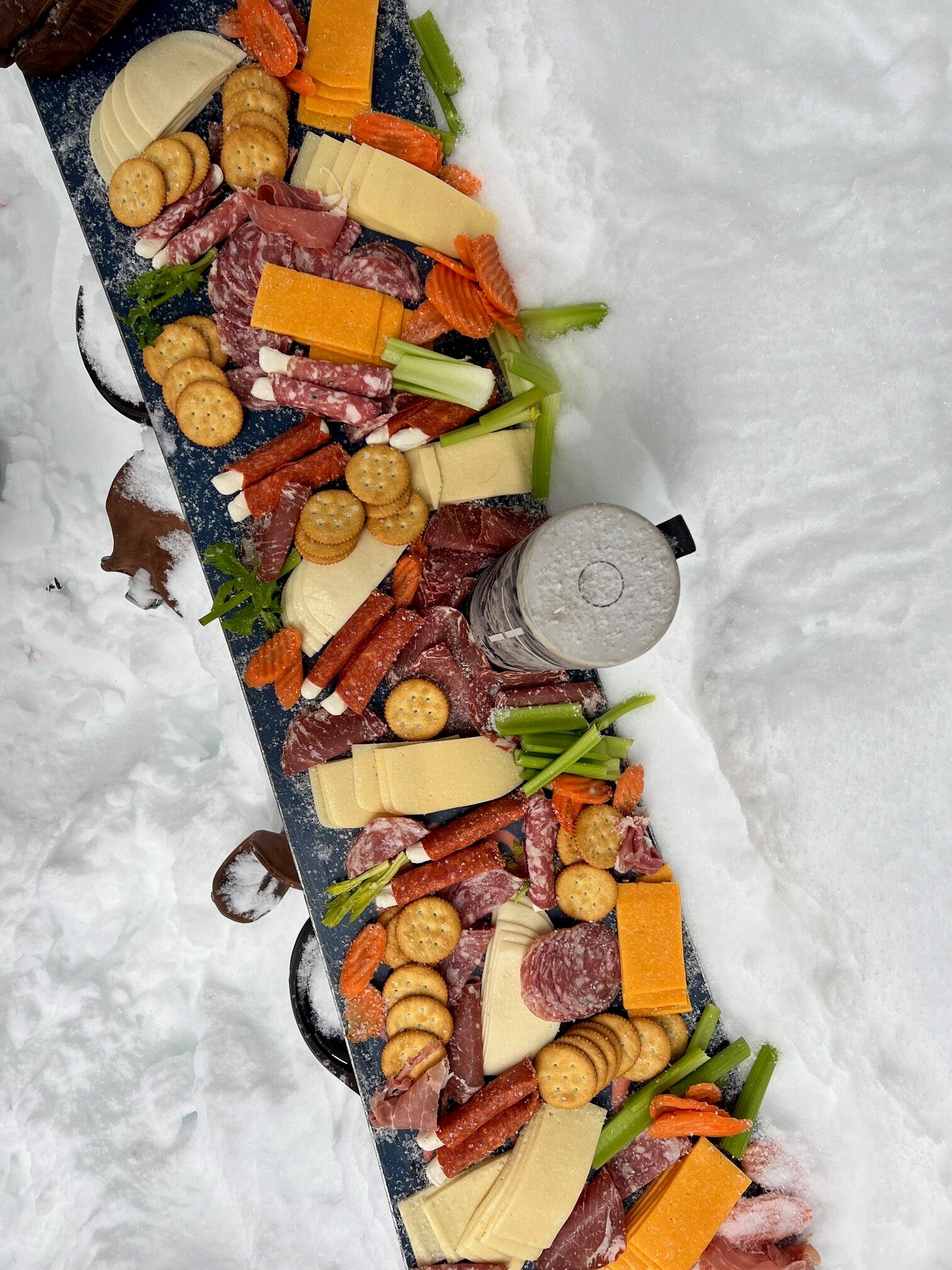 A charcuterie board on snow