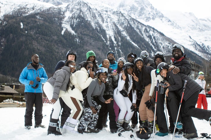 A group of black skiers in the alps