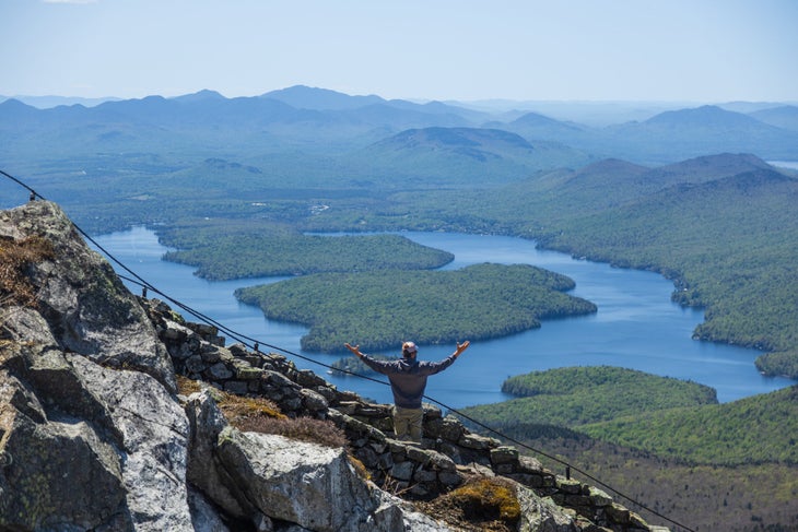 Man looks out over lake in Adirondacks at Whiteface