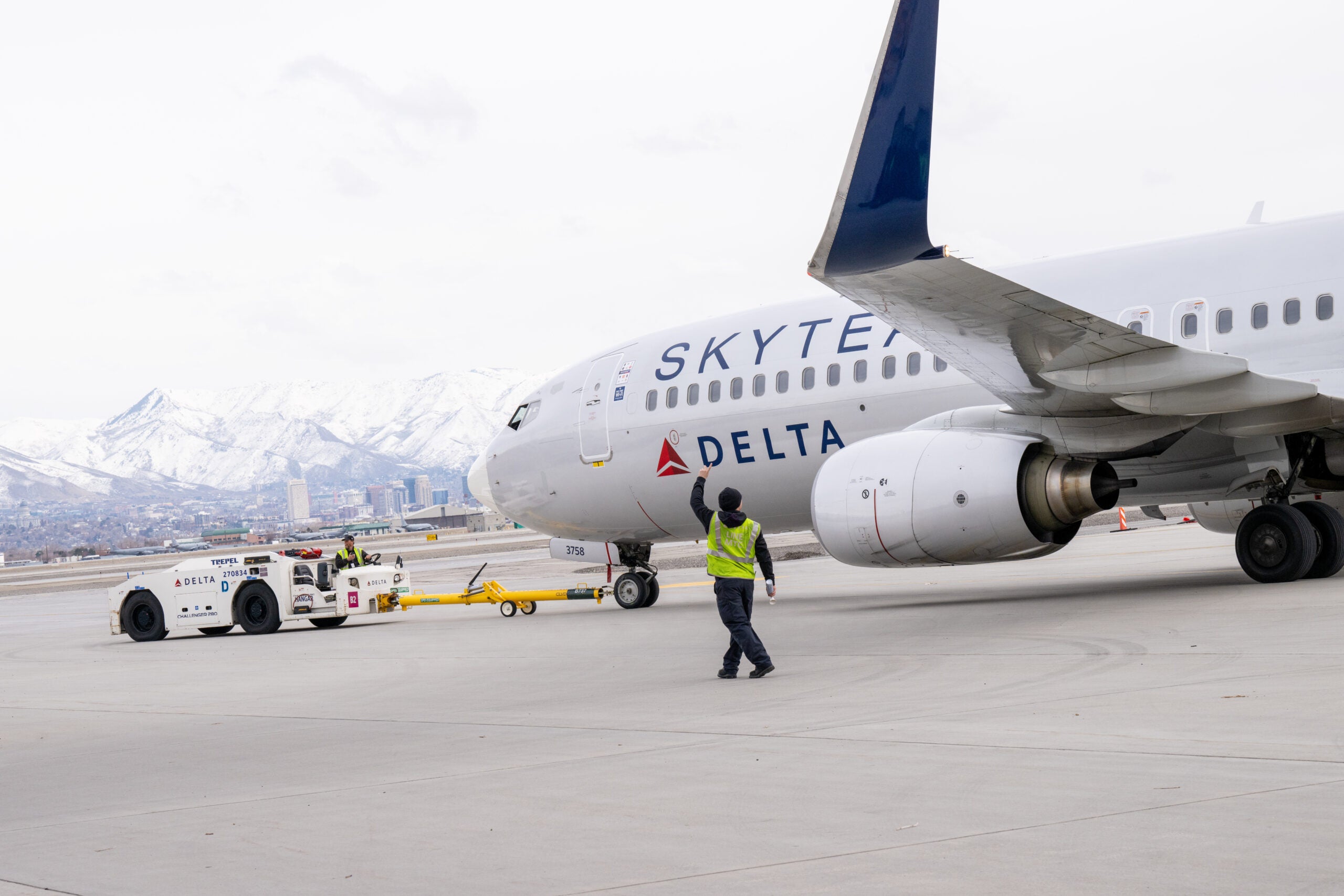 delta plane being pulled with mountains in the background