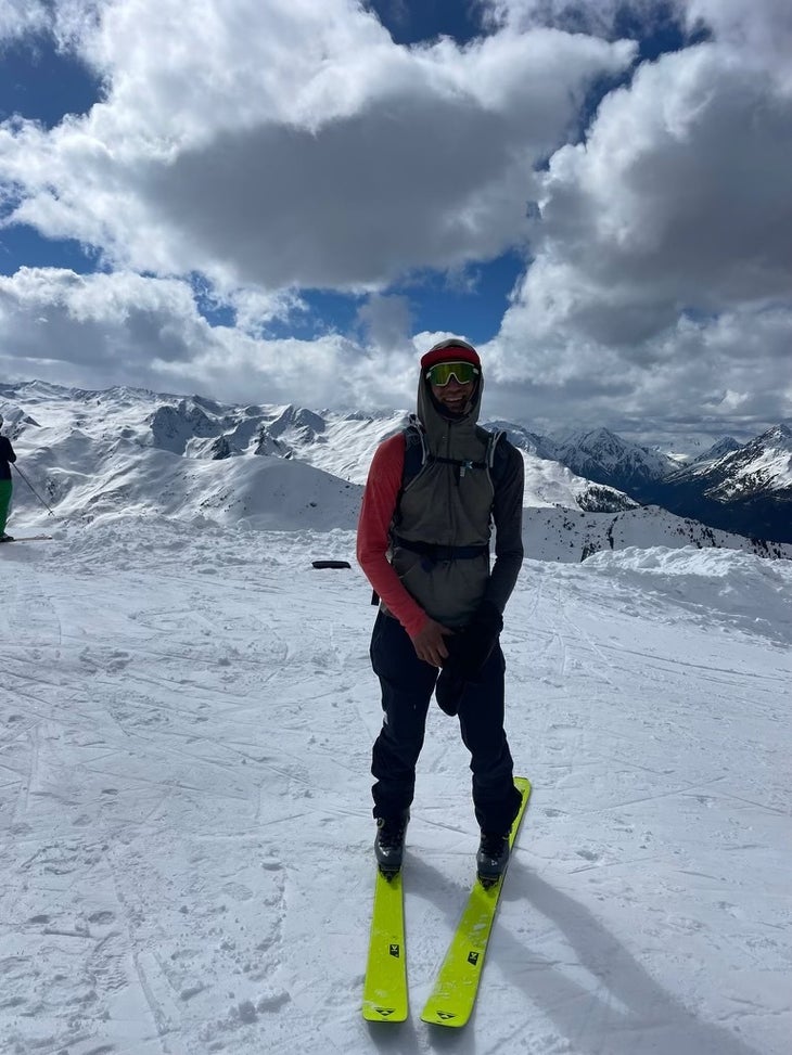 Noah Dines with red sleeves and neon green skis. 