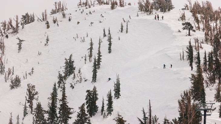 Skiers dropping into the Chutes at Mt. Rose ski resort, Nevada