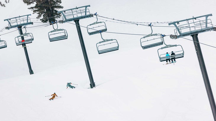 Skiers and a ski lift for a ski test