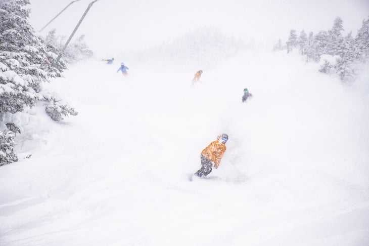 Snow covering several skiers at Jay Peak
