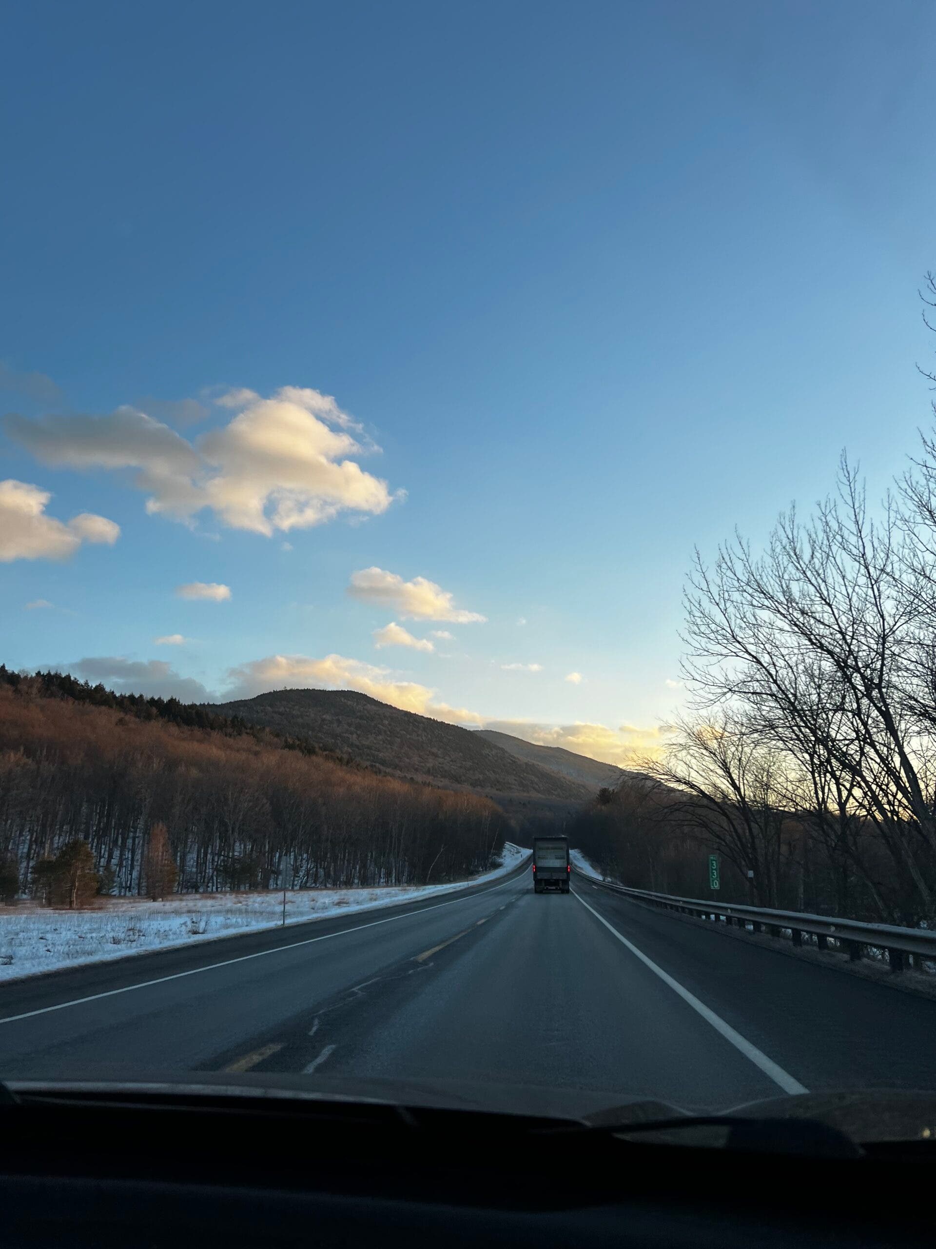 Sunset drive on a highway with a little bit of snow.