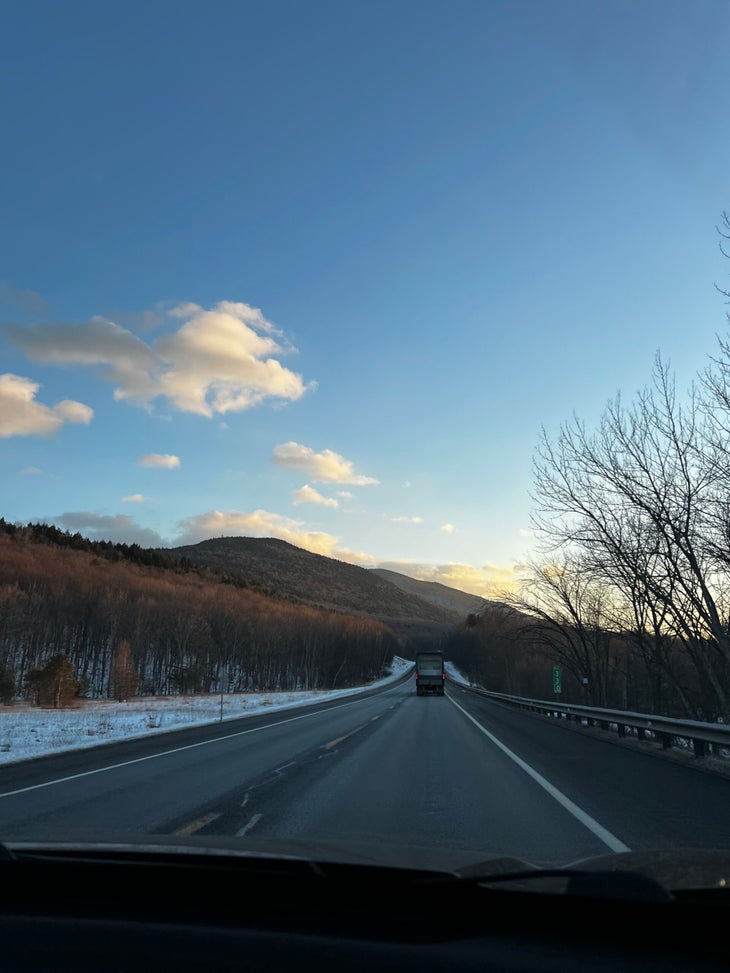 Sunset drive on a highway with a little bit of snow.