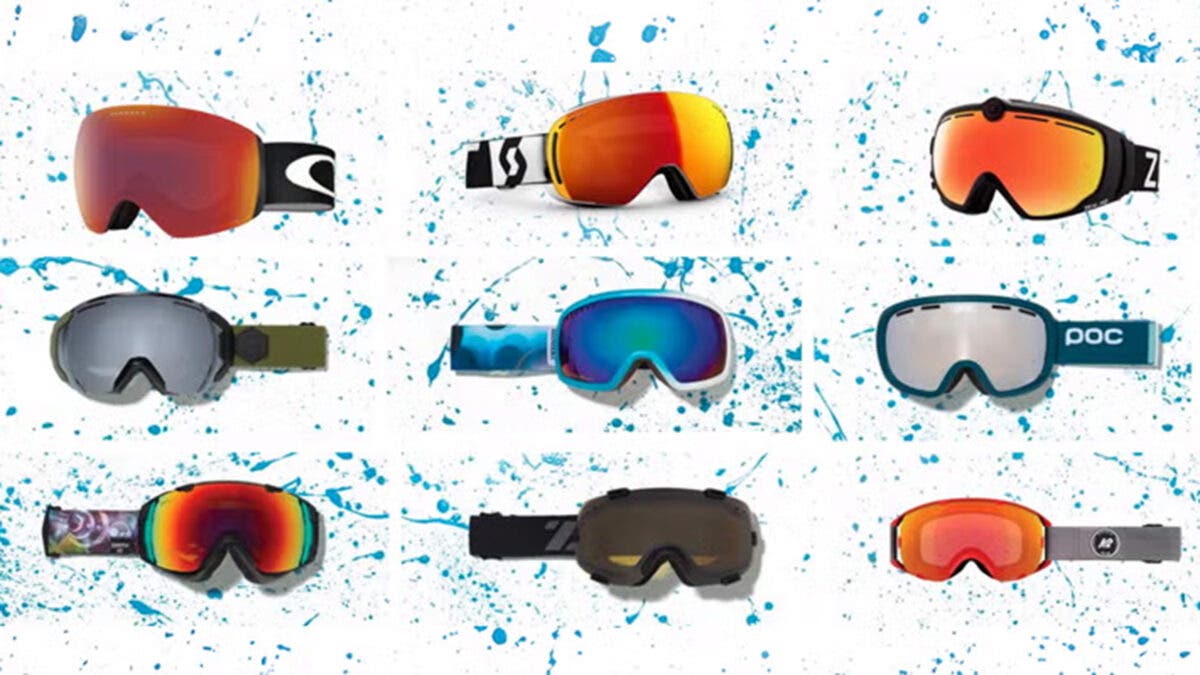 Closeup of various ski goggles displayed on painted background