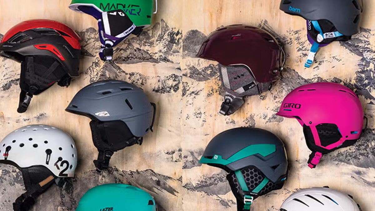 Closeup of various ski and snowboard helmets on decorative background