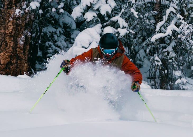 Skier charges through snow.