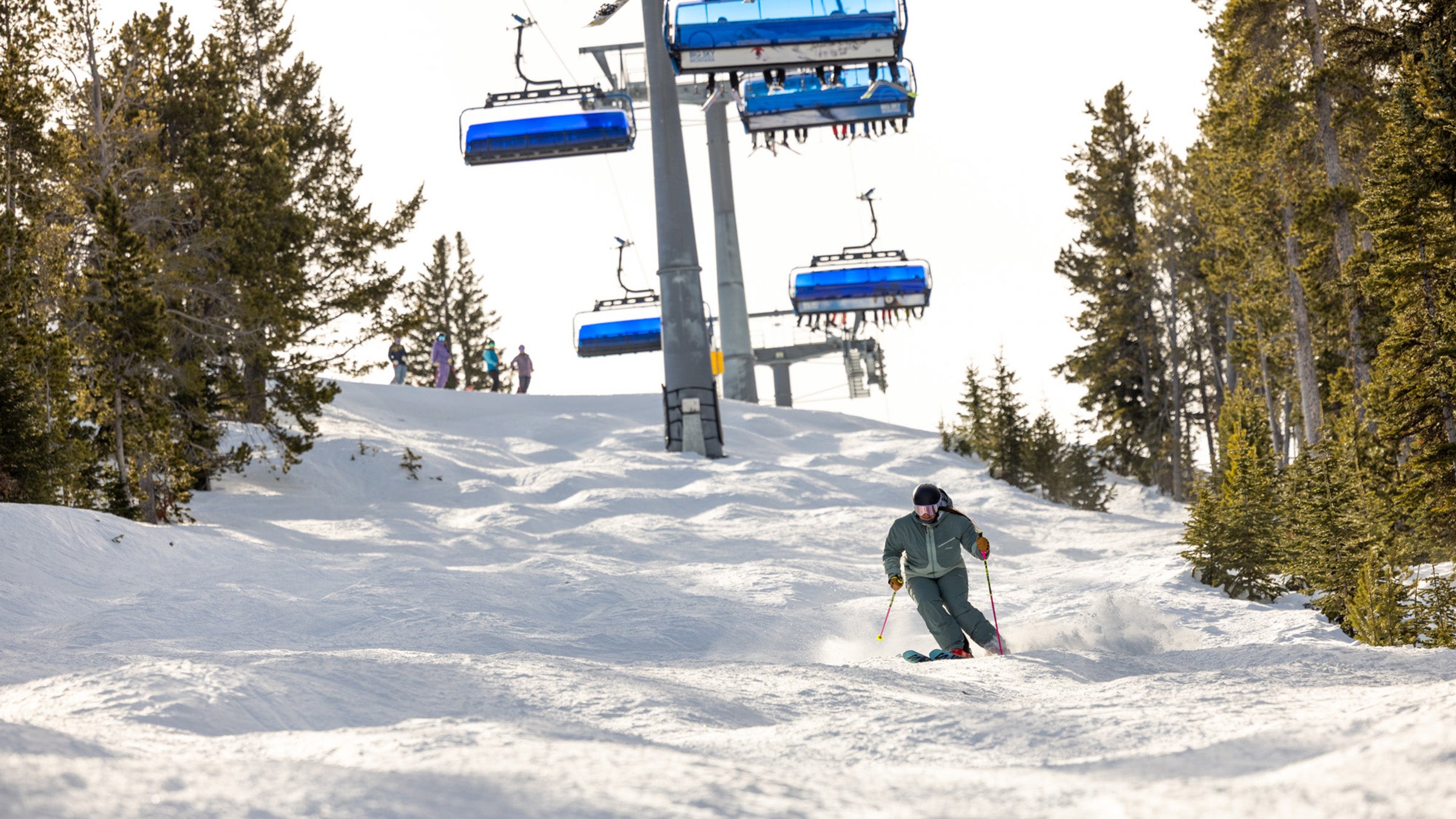 Skier coming down bump run under Big Sky Ramcharger chairlift