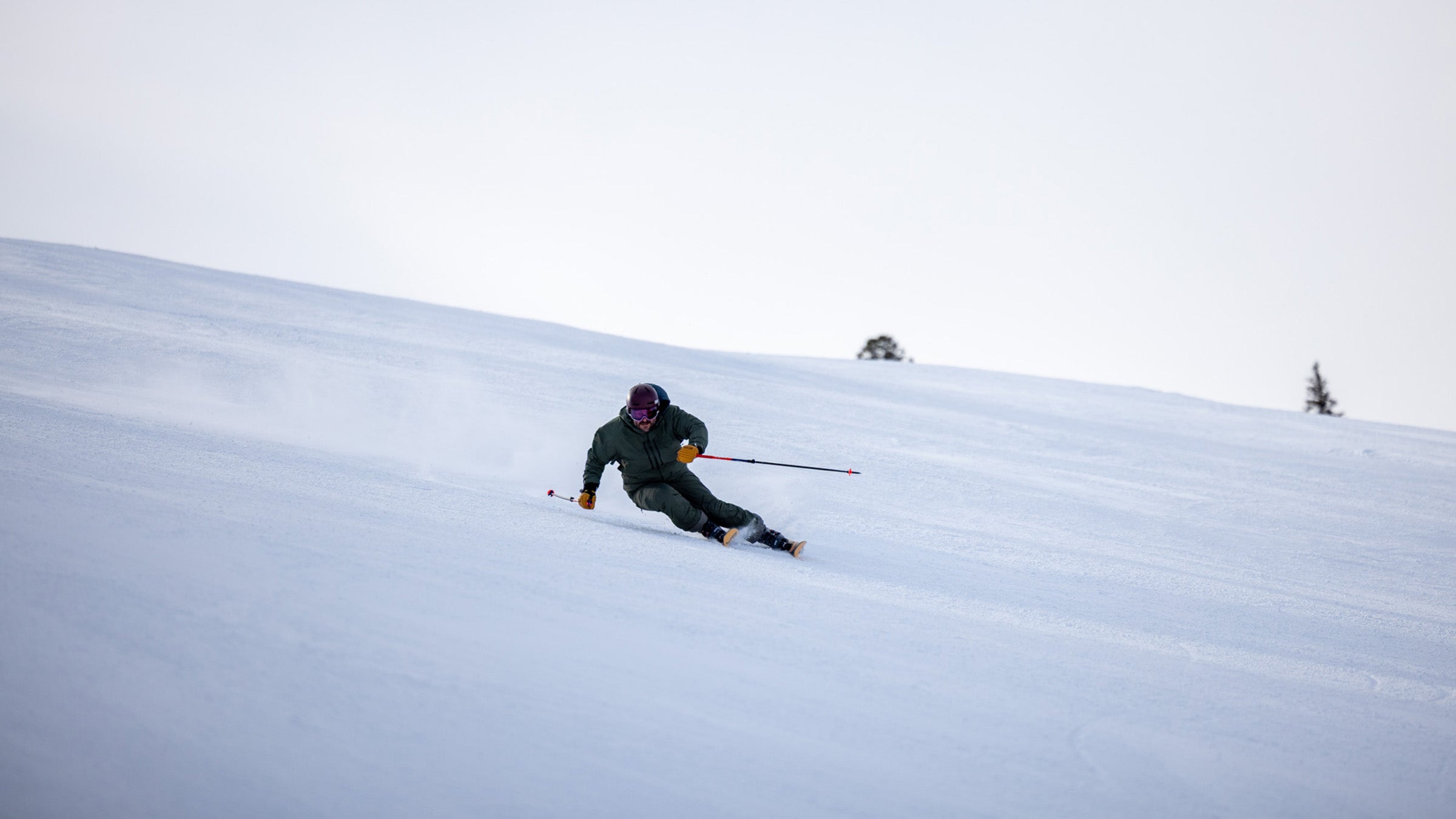 Skier carving on groomed slope